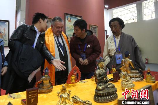 图为联合国世界旅游组织荣誉秘书长弗朗西斯科·弗朗加利(左二)参观藏羌彝文化产业走廊特色文化旅游精品展。　罗云鹏 摄